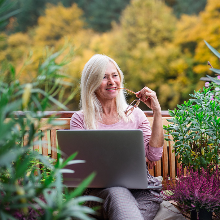 woman working on her computer on a terrace