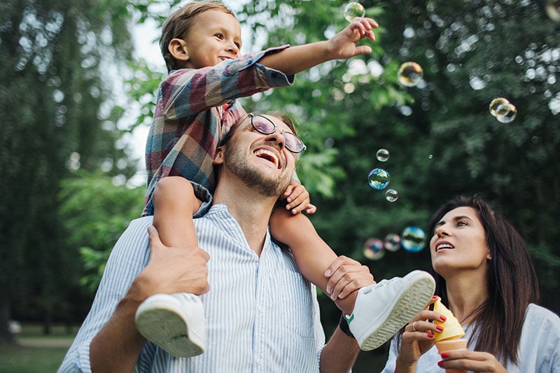 A family looking at bubbles