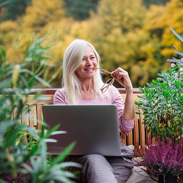 woman working on her computer on a terrace