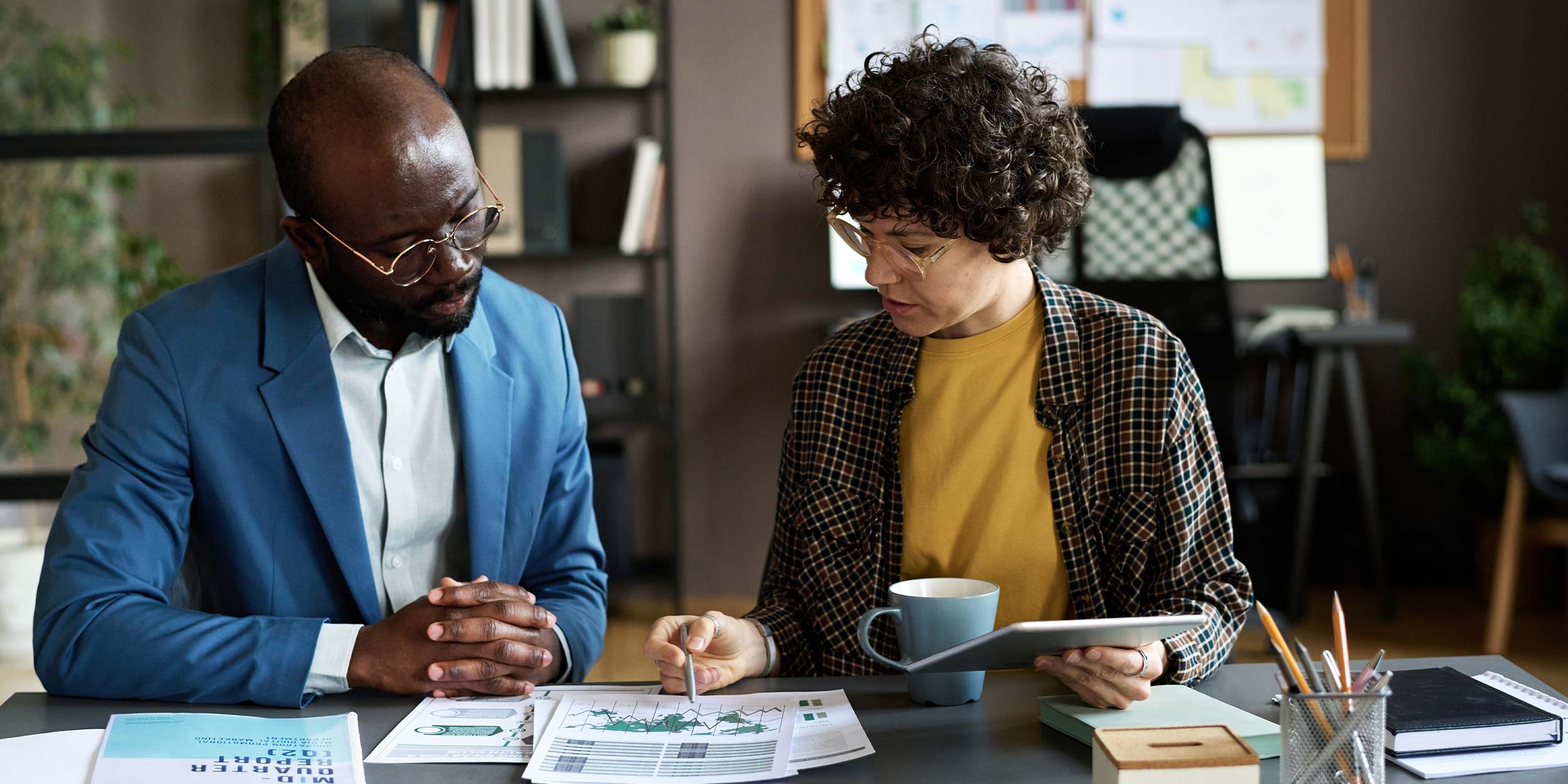 two people looking at documents together