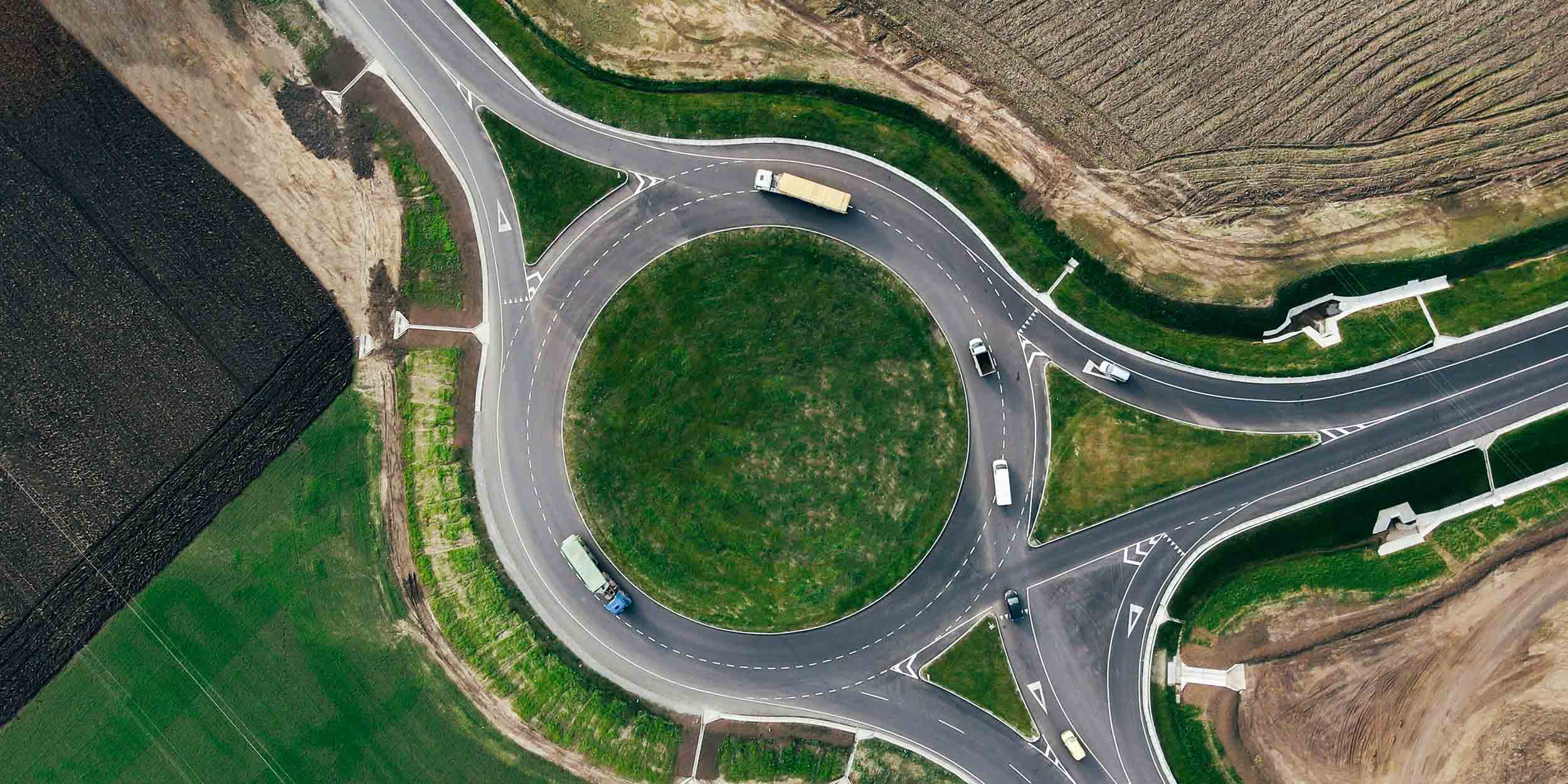 Roundabout traffic of cars and trucks on the circle ring road