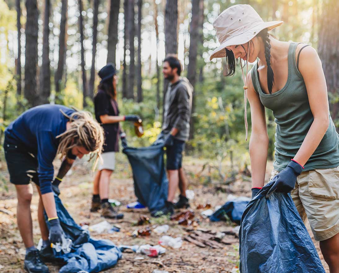 people collecting waste in the forrest