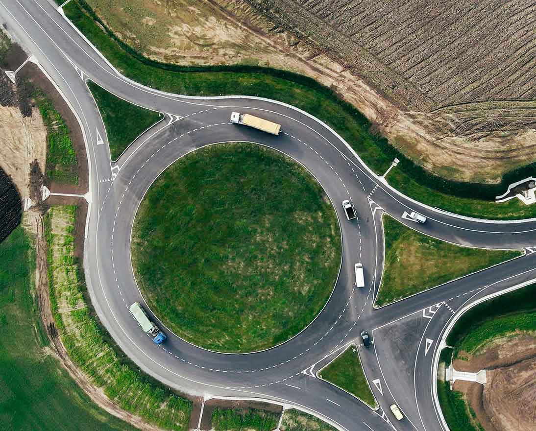 Roundabout traffic of cars and trucks on the circle ring road