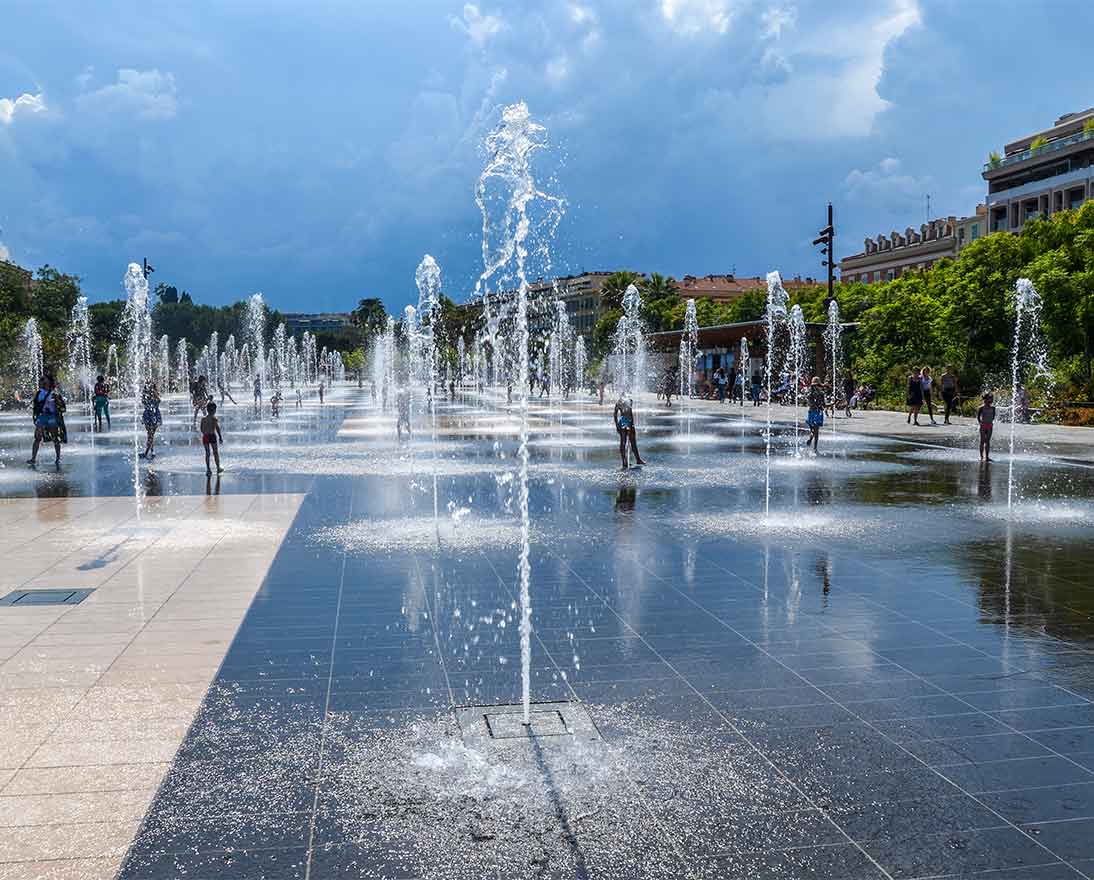 Kids playing in the water of fountains 