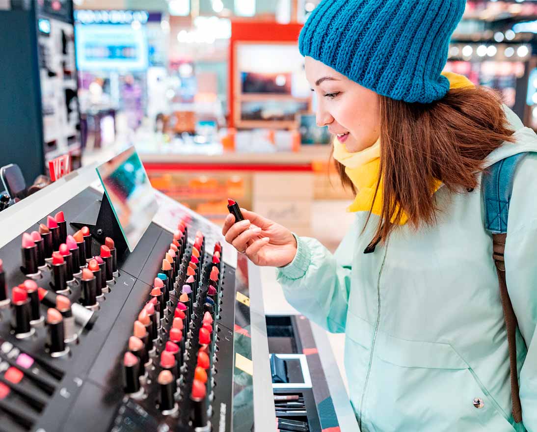 Woman shopping for lipstick and other cosmetics in a store