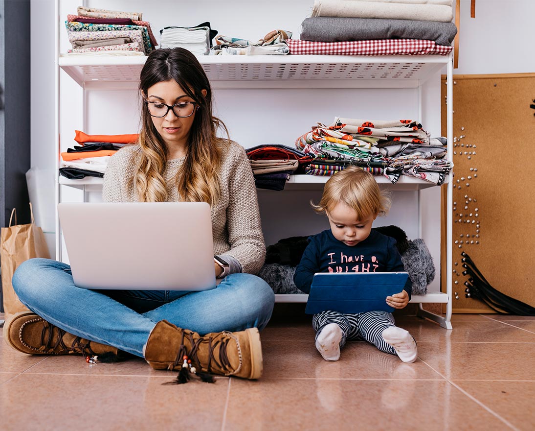 woman and child on floor holding devices