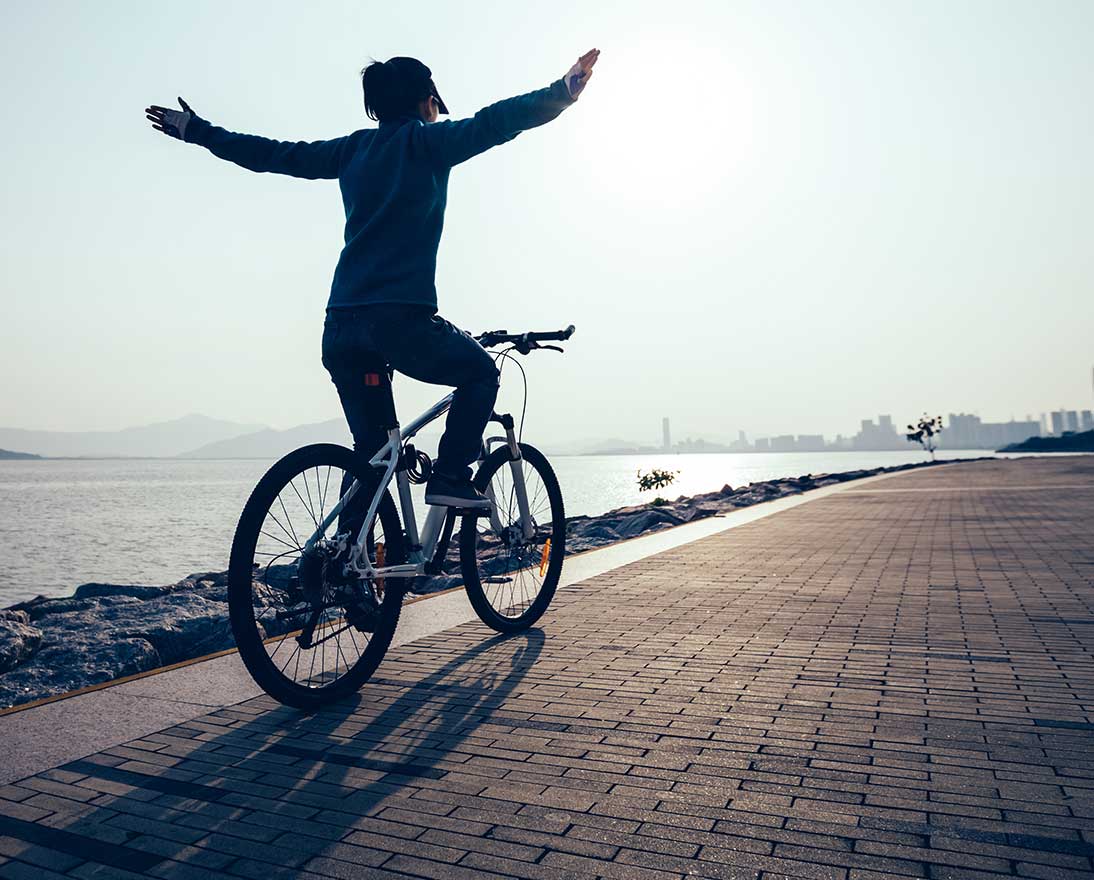 woman riding a bike at beach