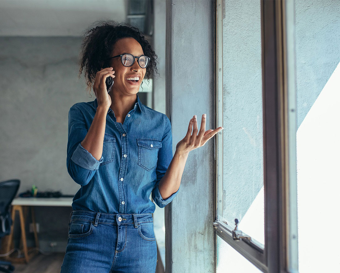 Cheerful young woman talking on mobile