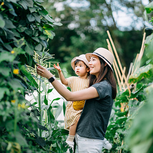 mother and doughter looking at plants