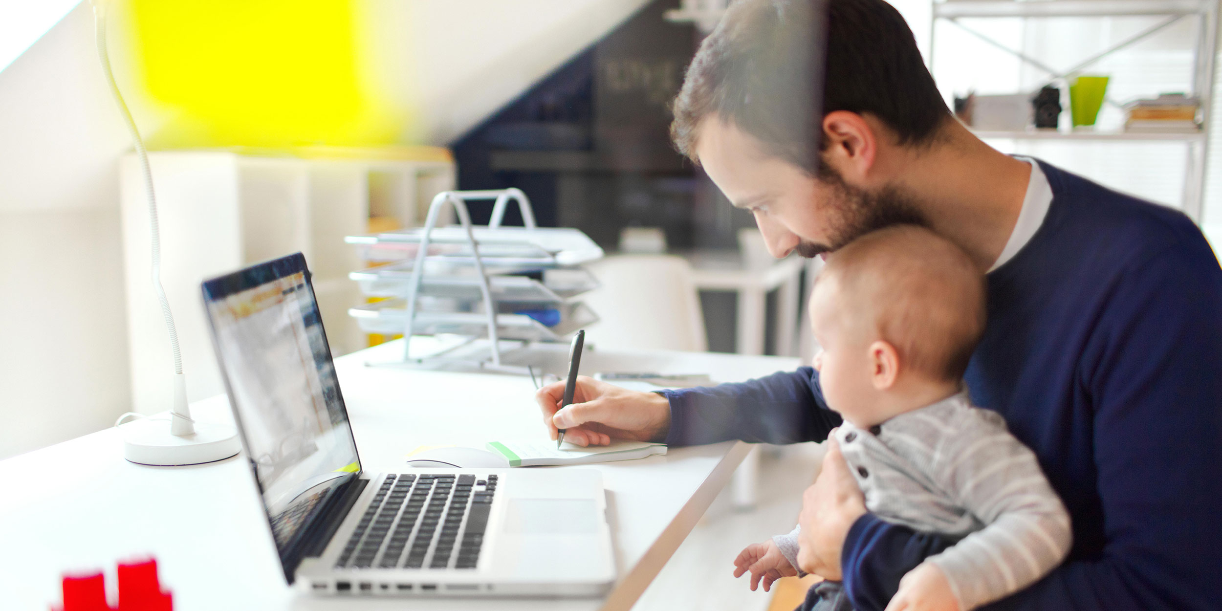 father working with son on lap