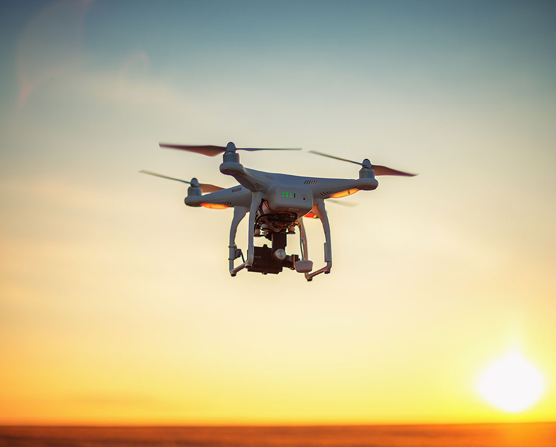 Flying drone during sunset