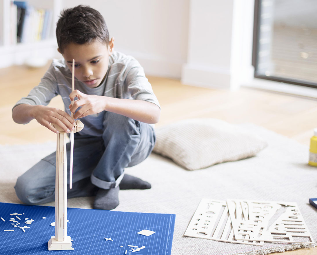 boy building windmill model