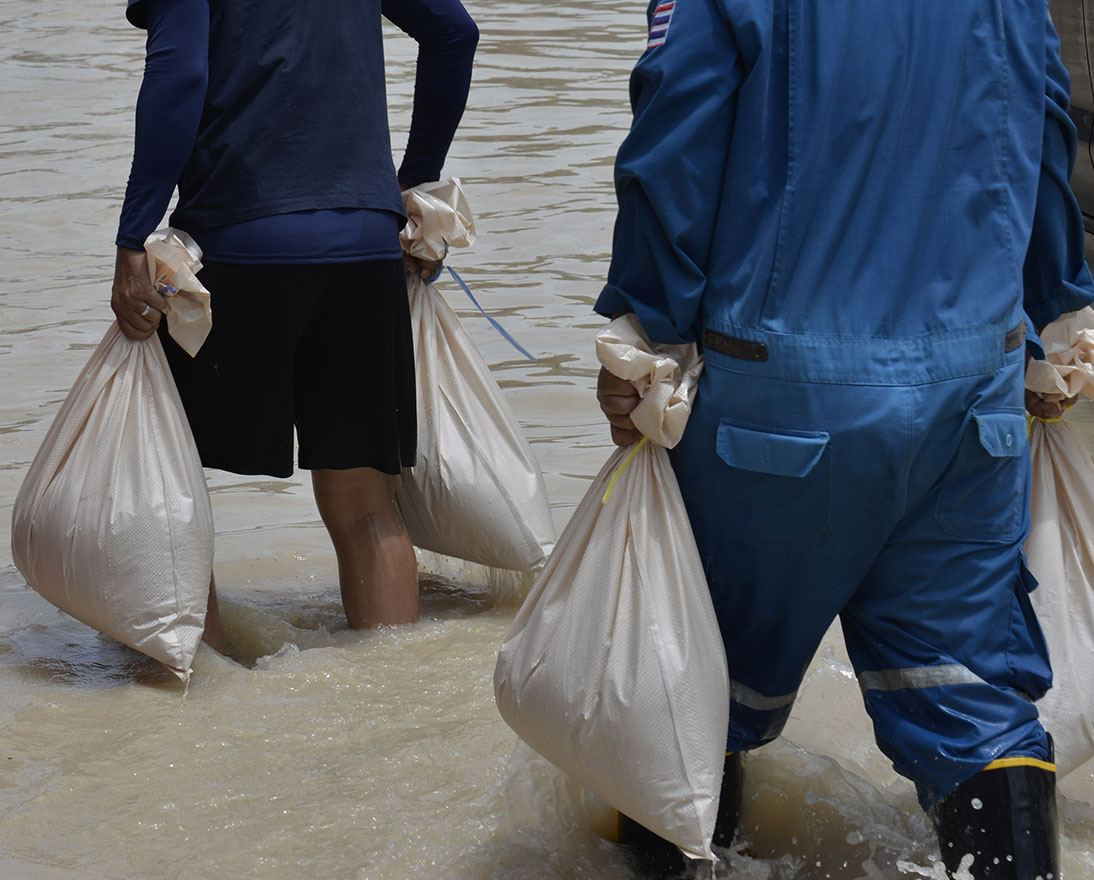 people walking in flood