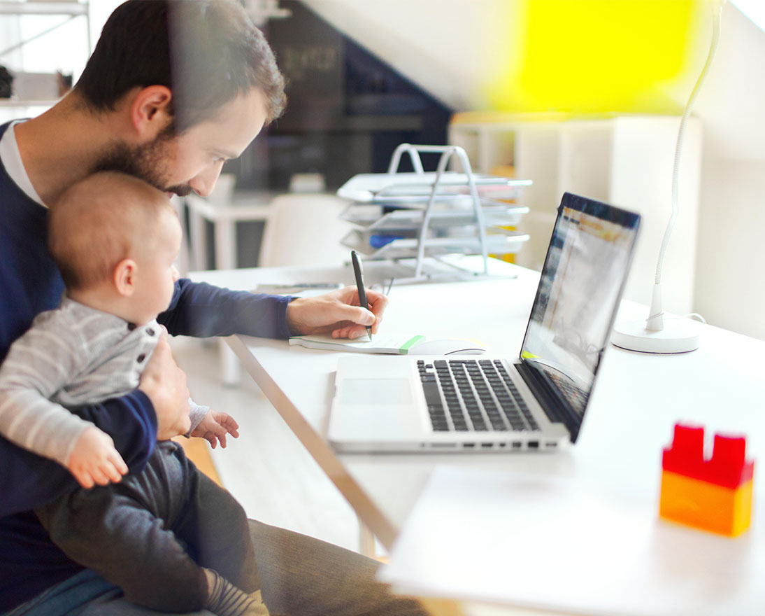 father working with son on lap