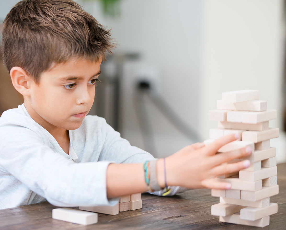 boy playing jenga