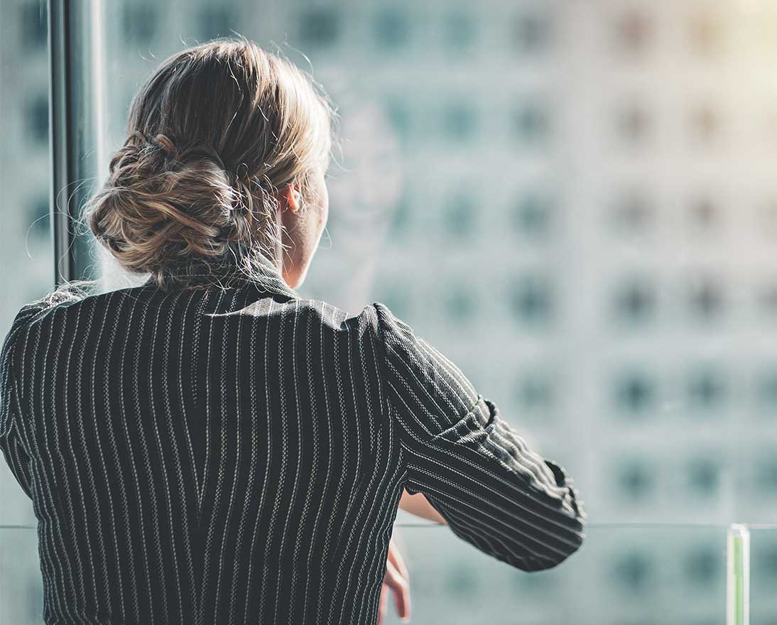 woman looking outside of the window