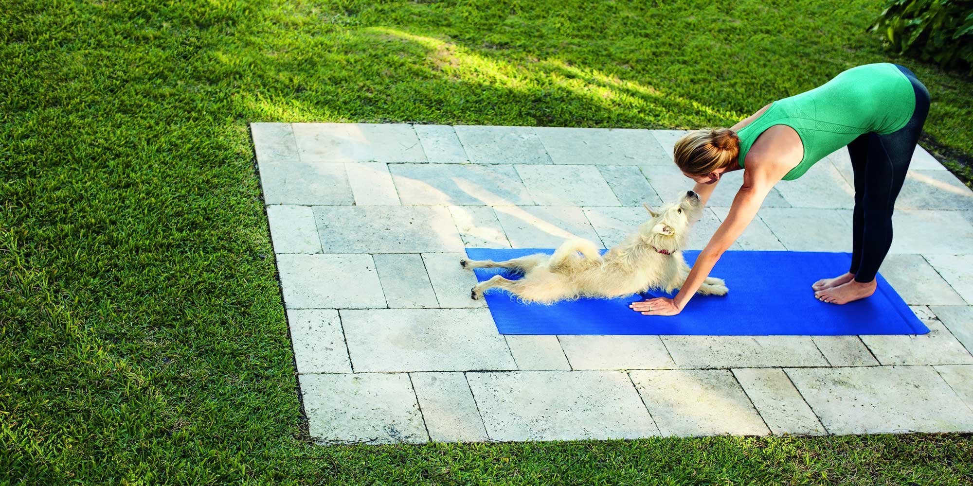 woman and dog on blue mat