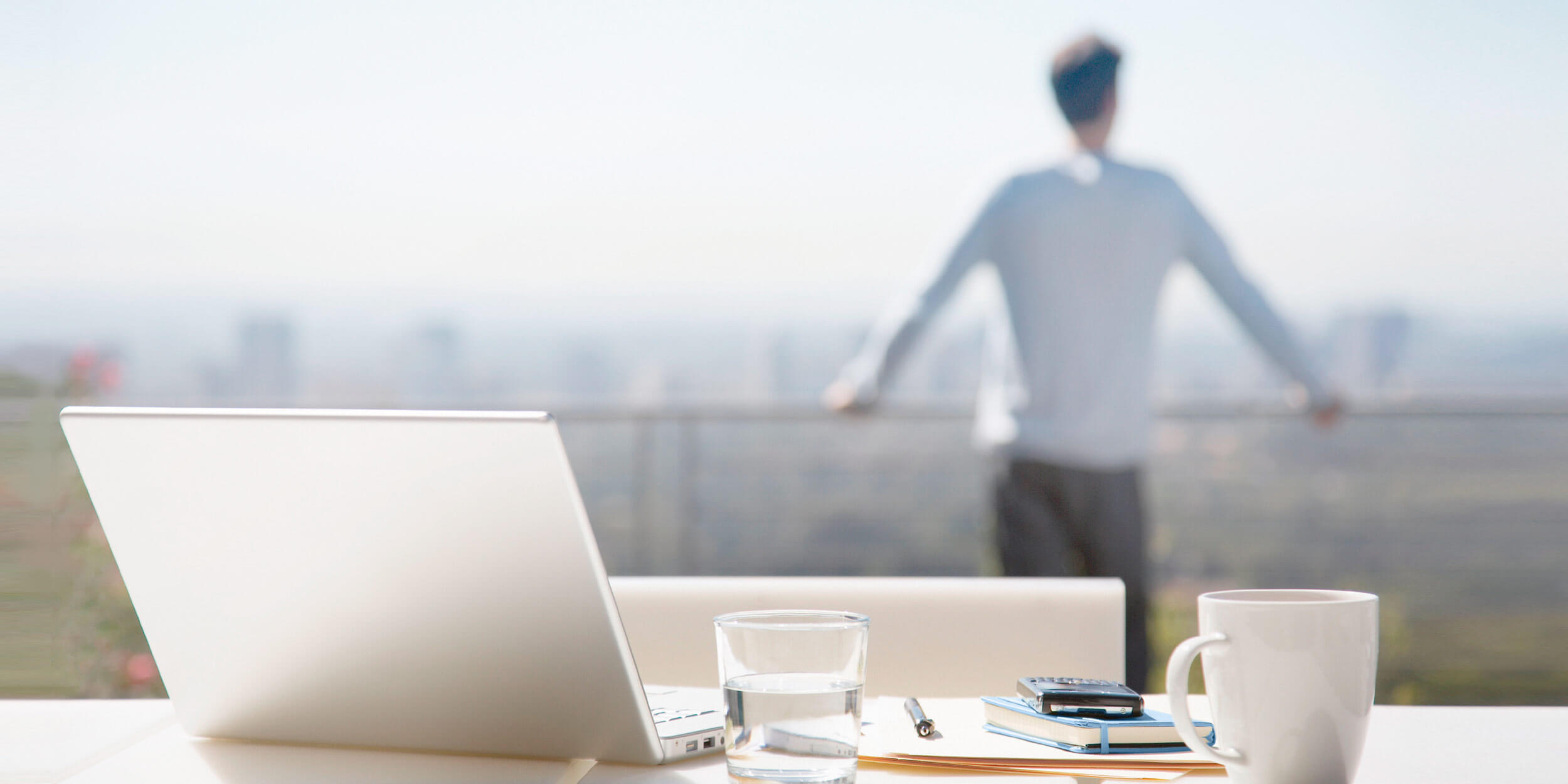 Image of man with laptop and coffee