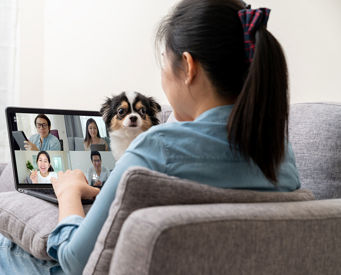 girl holding dog and tablet