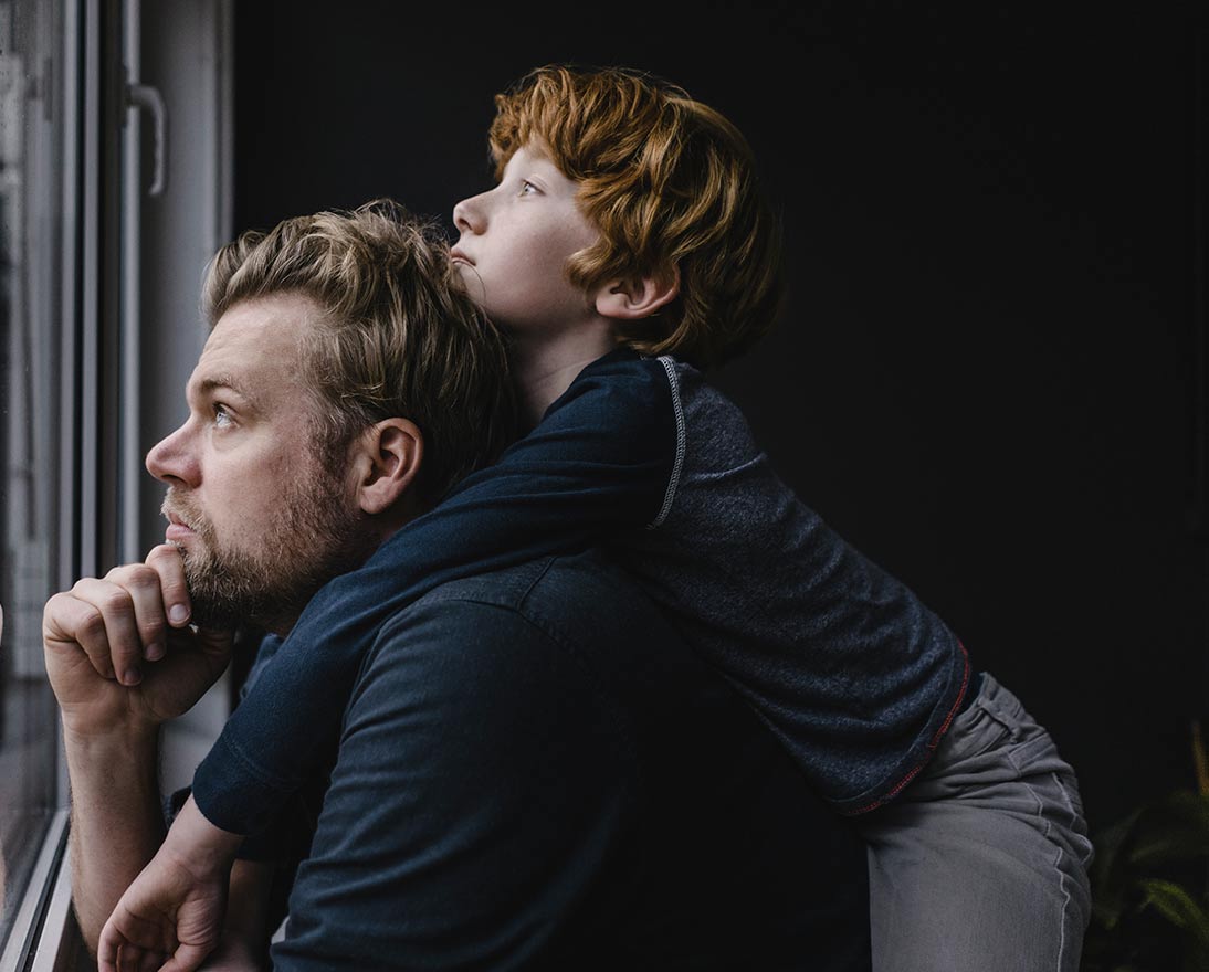 man and boy looking out the window