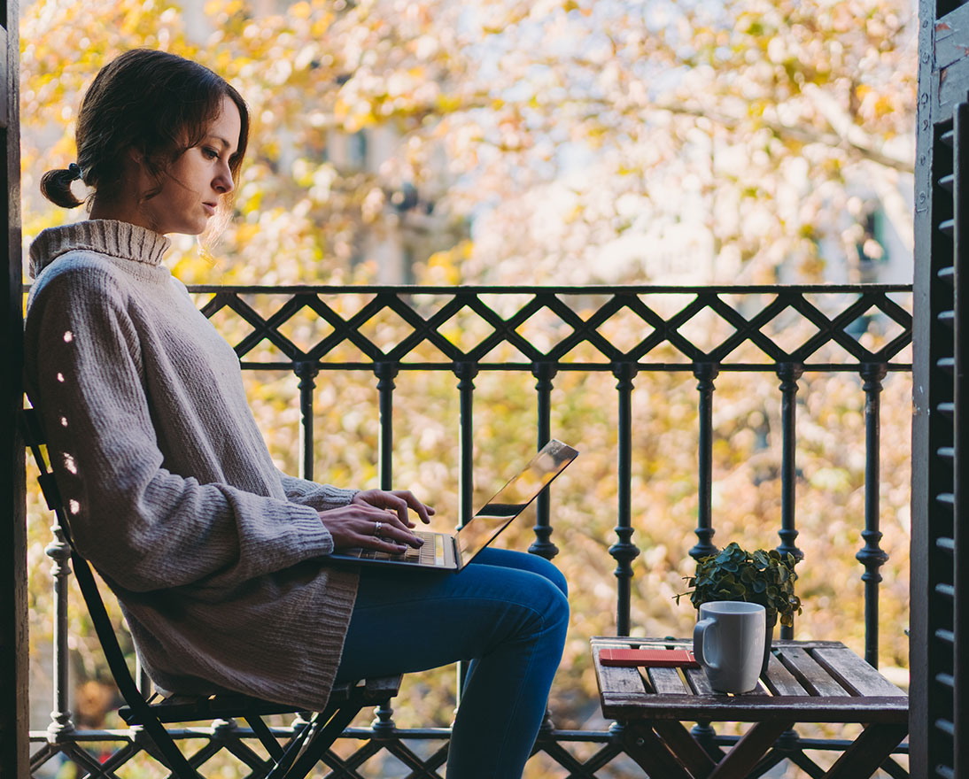woman working on balcony
