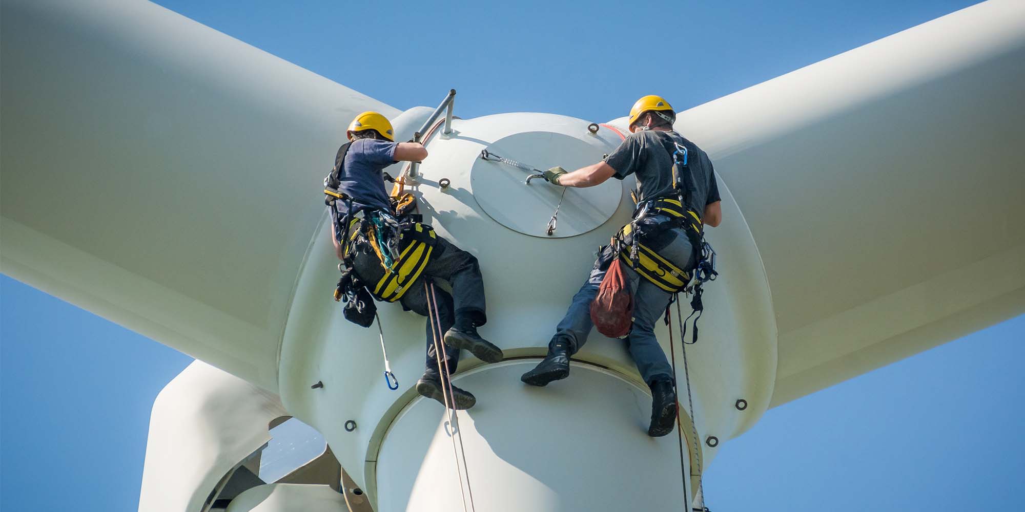 two workers walking in a factory area