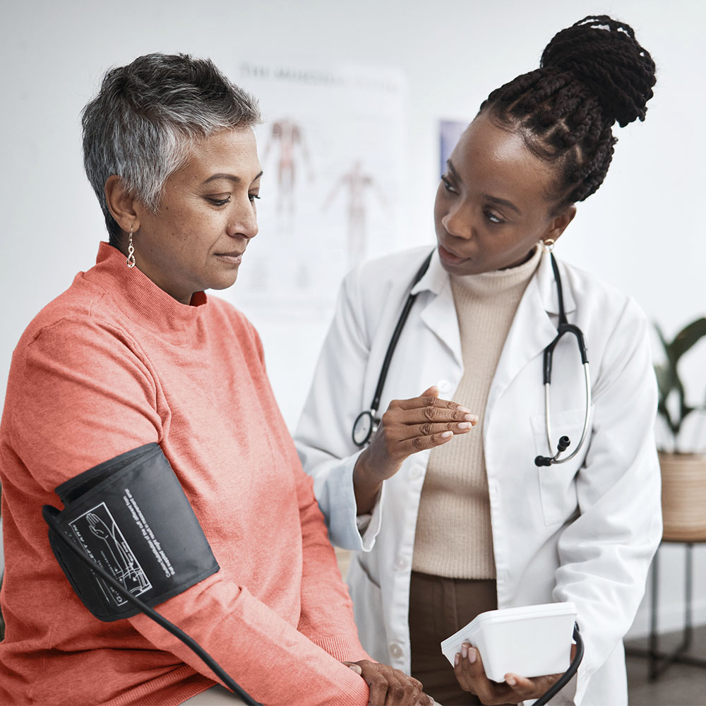 Healthcare professional discussing care plans with a patient in a clinical setting