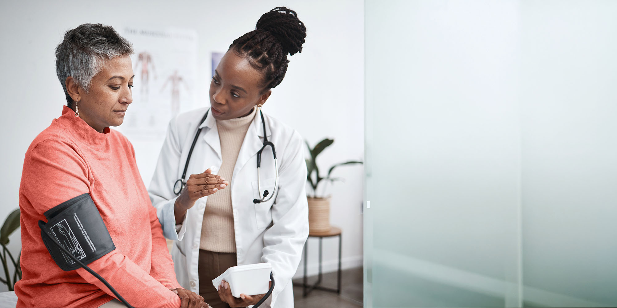 Healthcare professional discussing care plans with a patient in a clinical setting