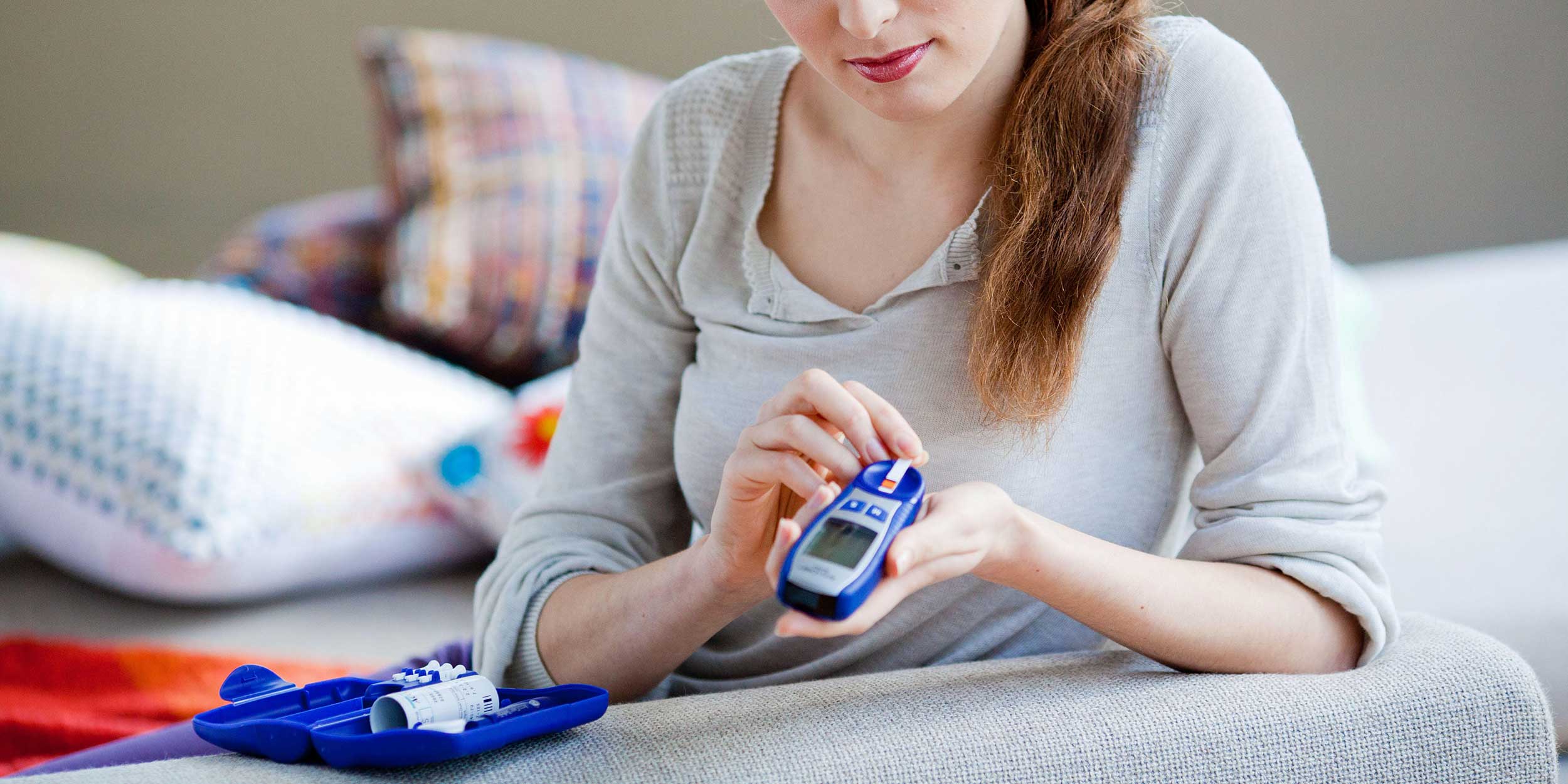 girl checking blood glucose level