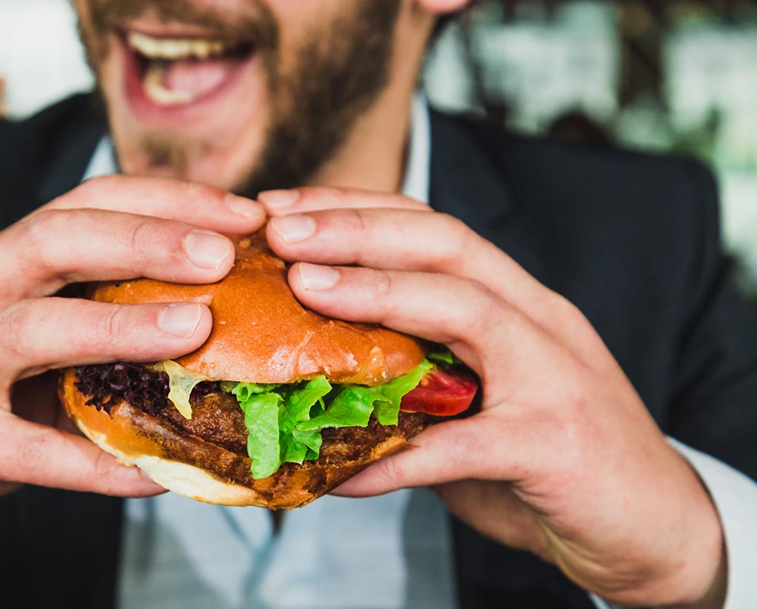 hands holding burger