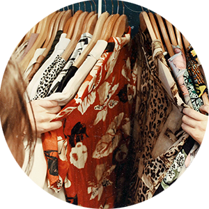 woman going through clothes at a second hand shop