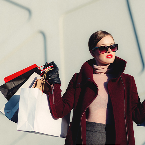 woman carrying multiple shopping bags