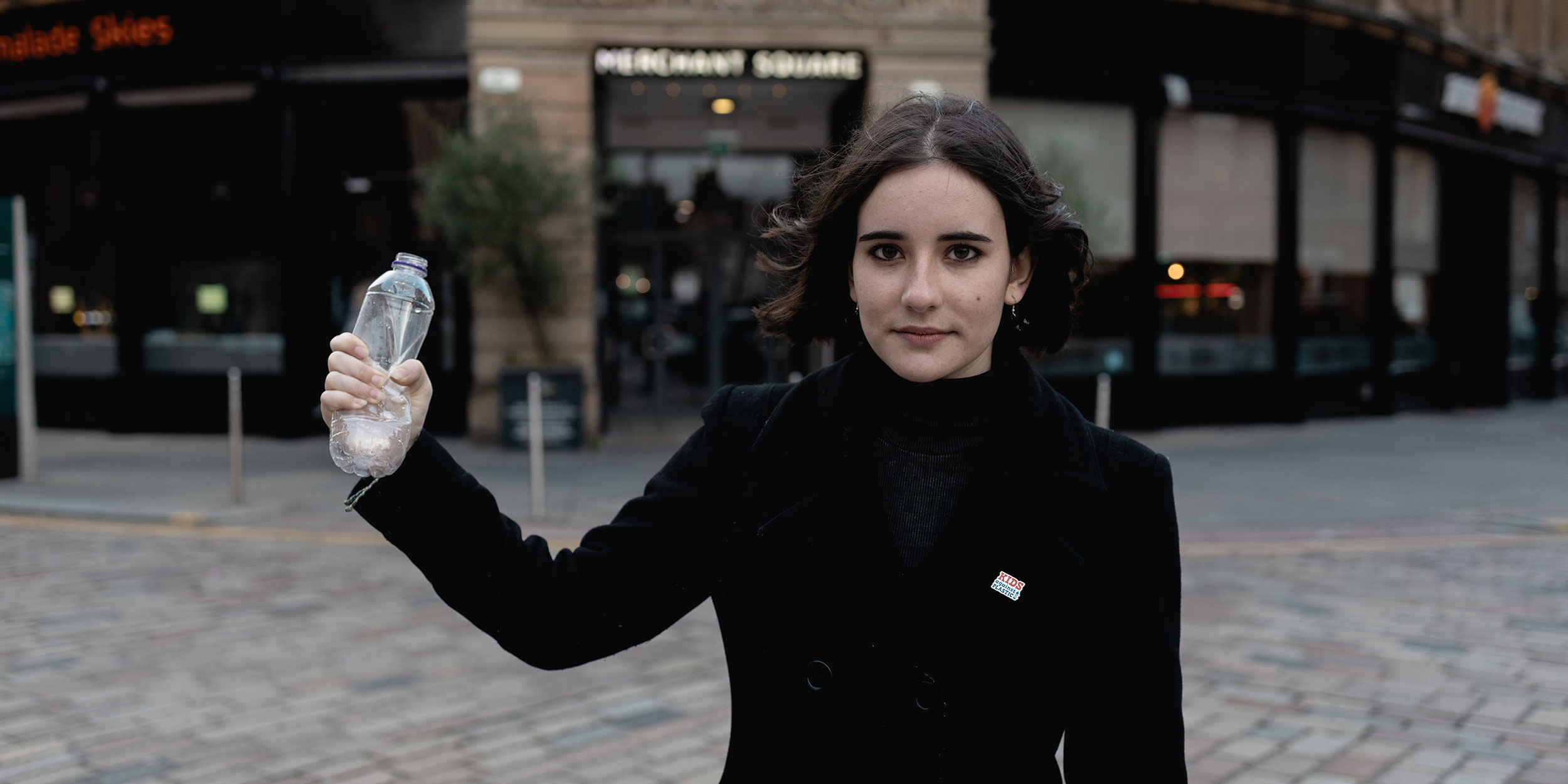 Amy squashing a plastic bottle