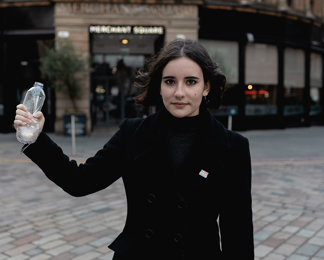 Amy squashing a plastic bottle