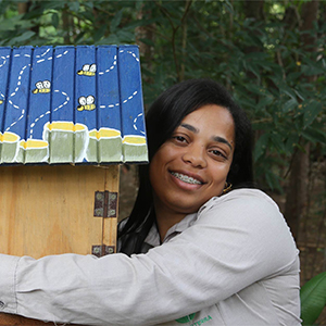 Kayla Maria Alves Fagiole, from Instituto Terra, hugging a stingless bee hive