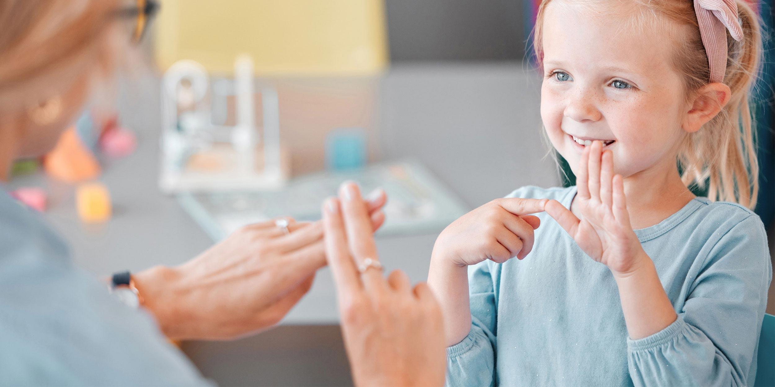 Deaf child learning sign language