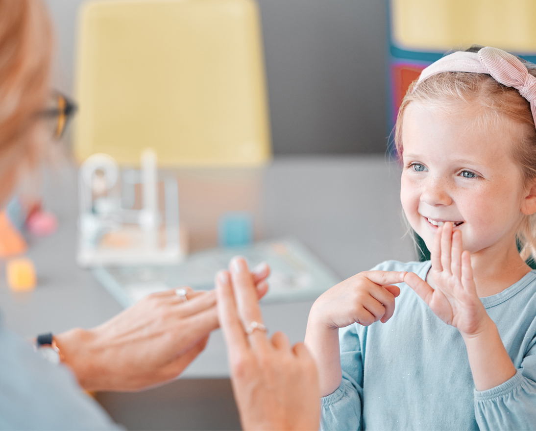 Deaf child learning sign language