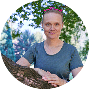 Linda Freiner leaning on tree