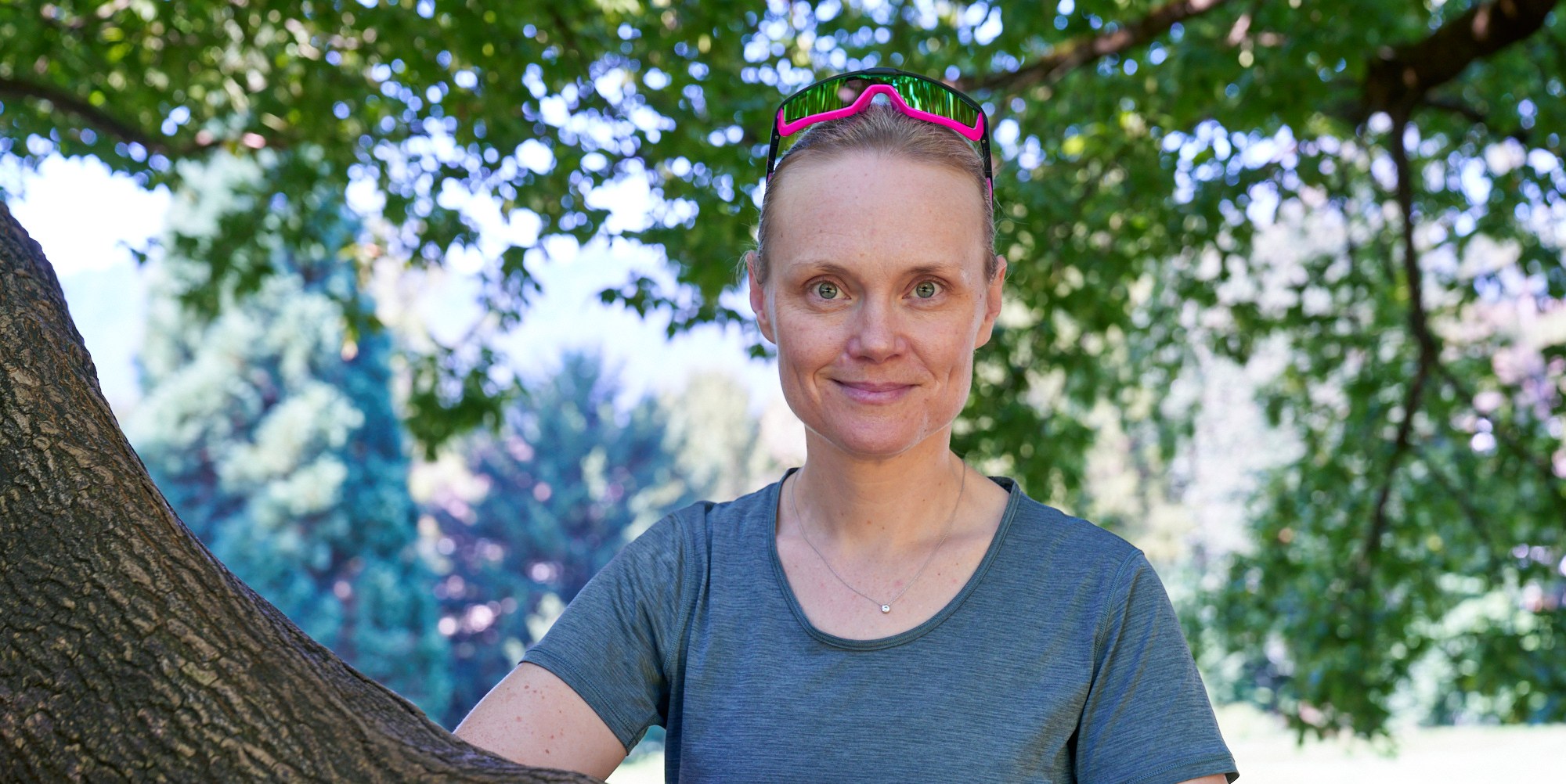 Linda Freiner posing with a tree