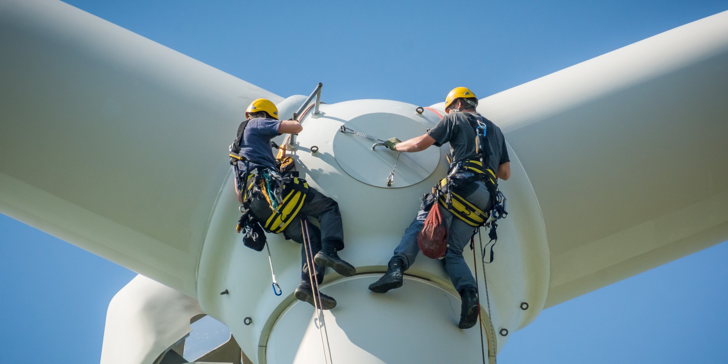 men working on an electric windmill