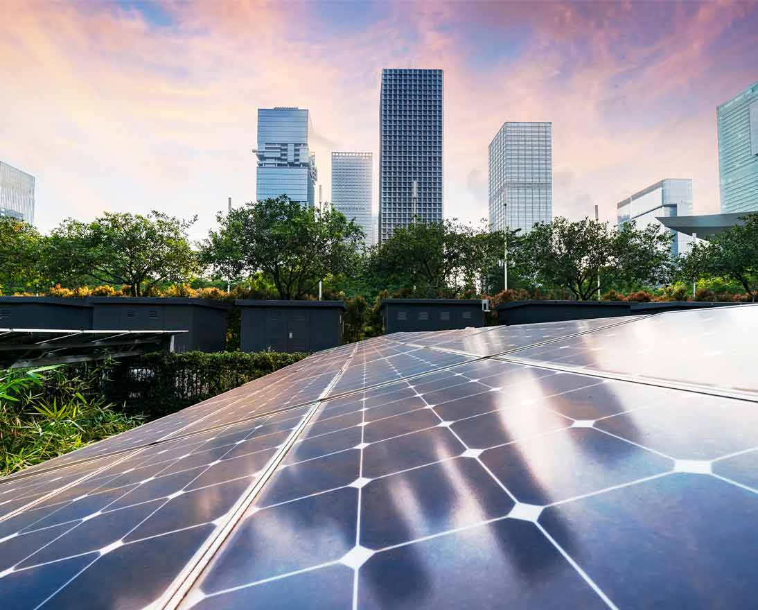 Solar panel plant with urban modern building landscape landmarks in sunset