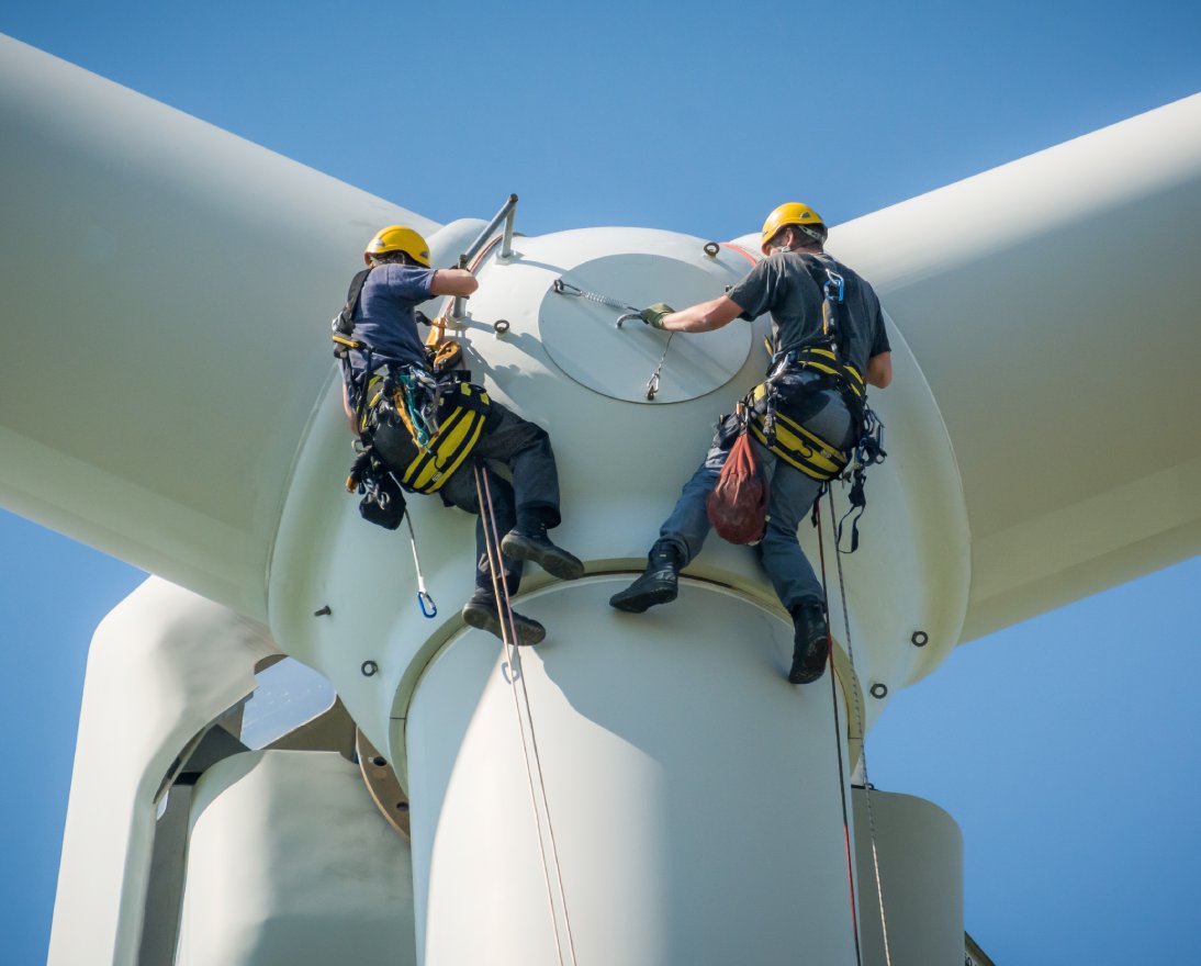 men working on an electric windmill