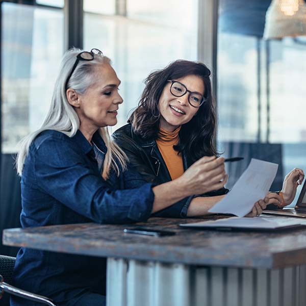 Two women working together at a desk