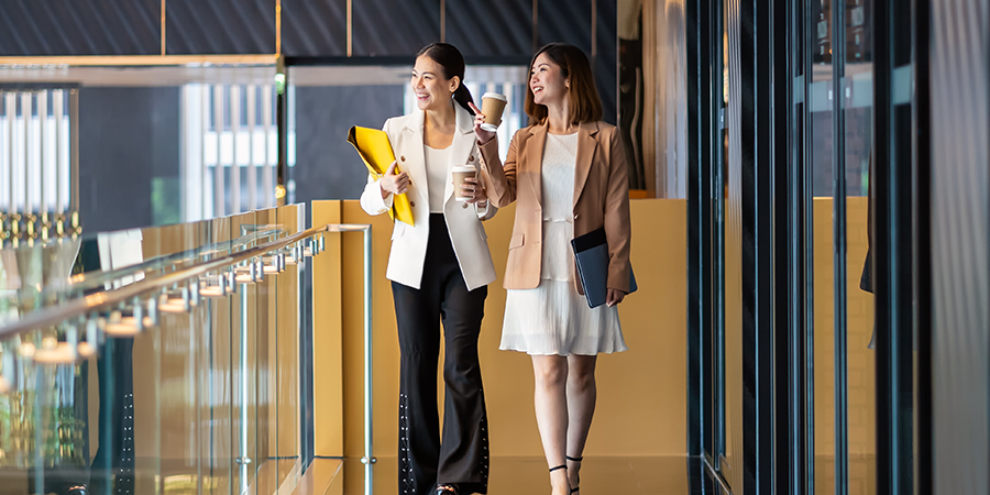 two woman walking down the hall