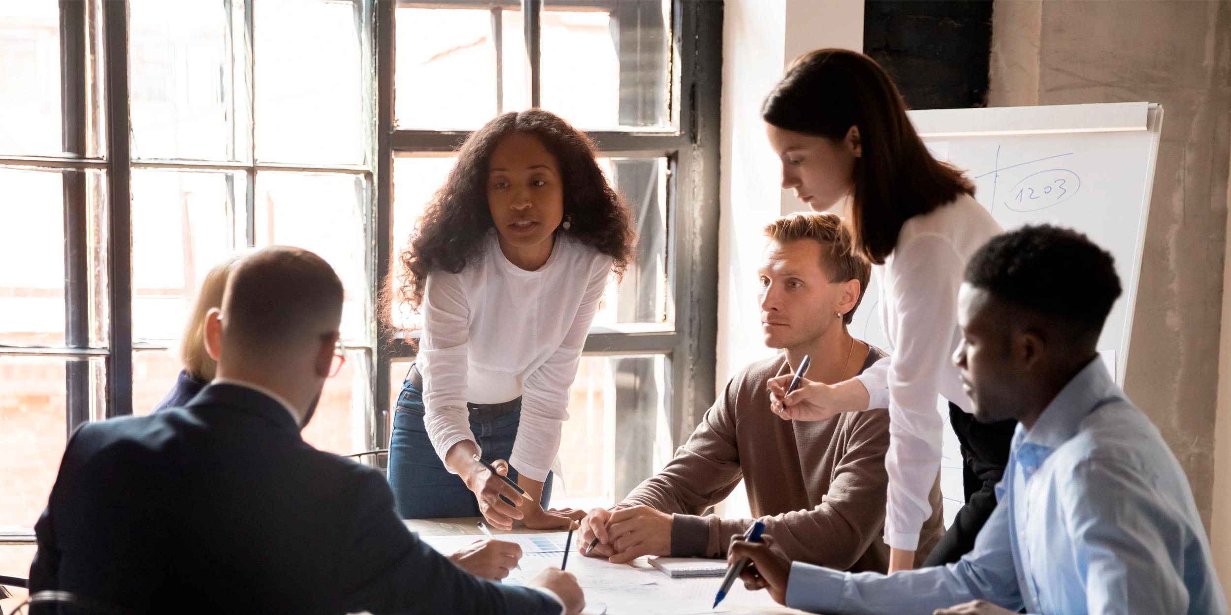 Group of people discussing project in meeting room