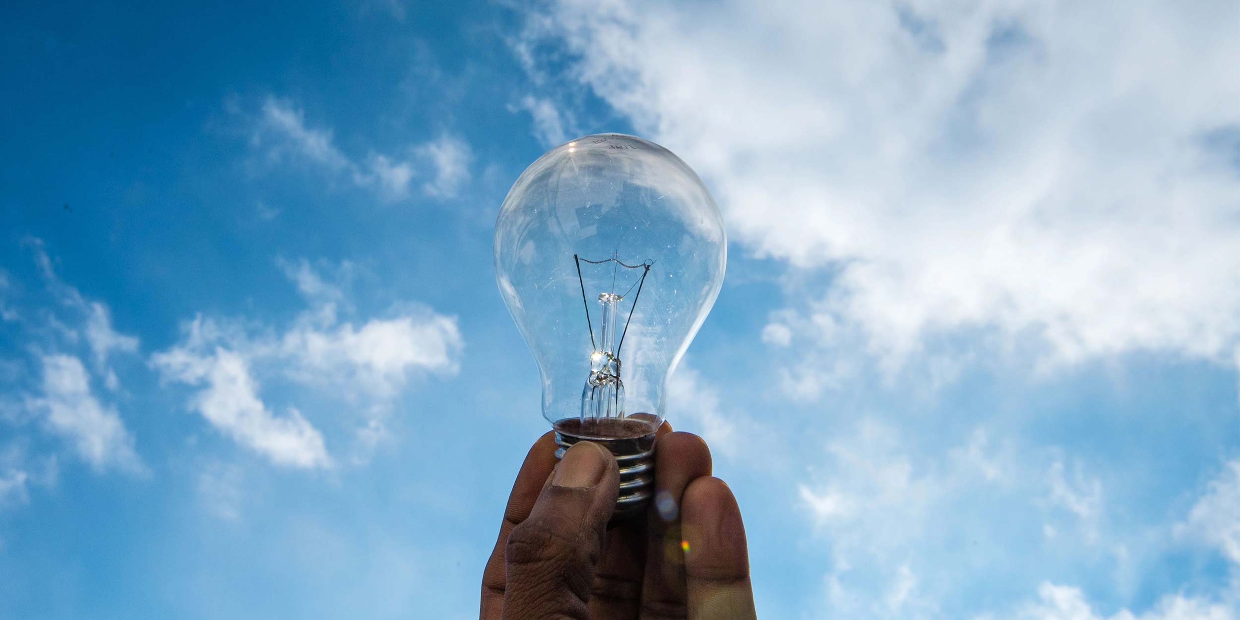 hand holding a light bulb