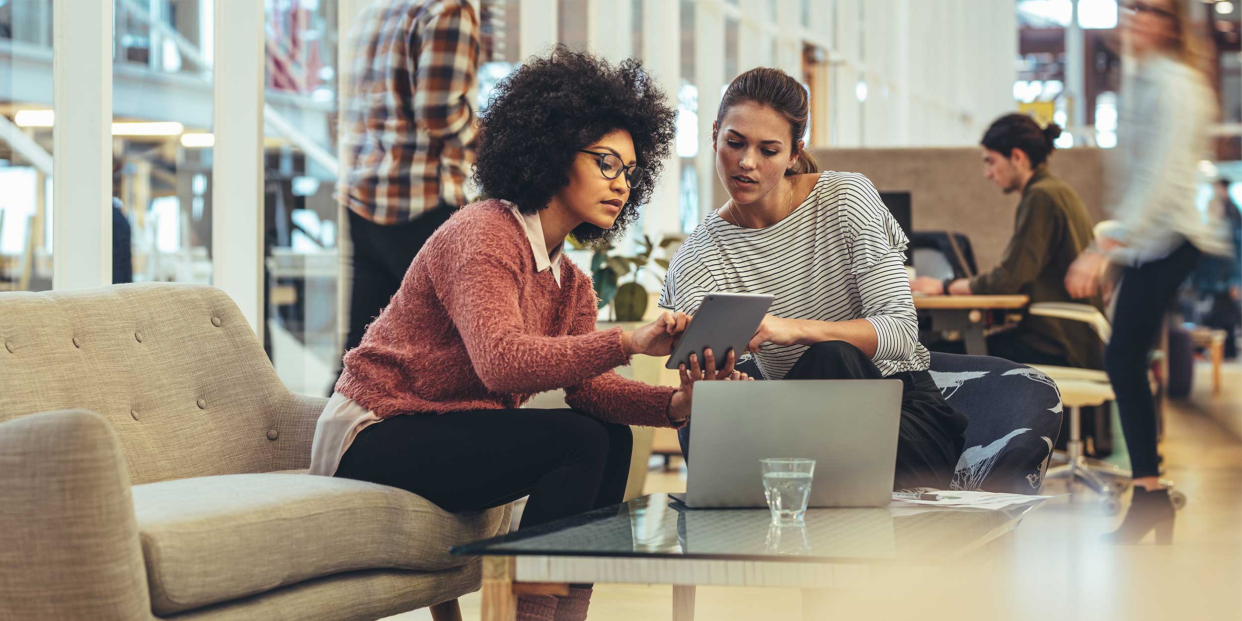 two women working on tablet