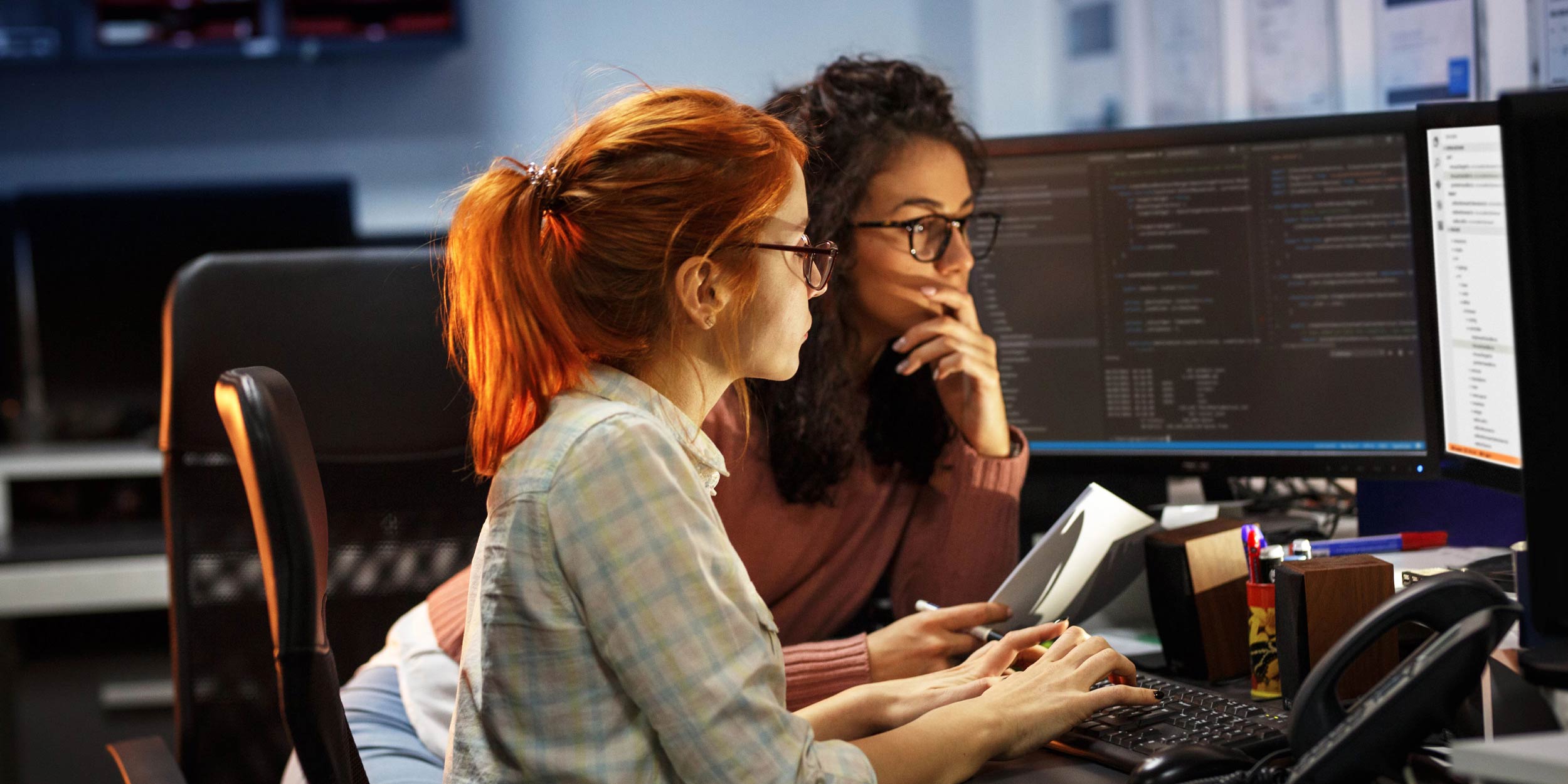 Two female programmers working on project