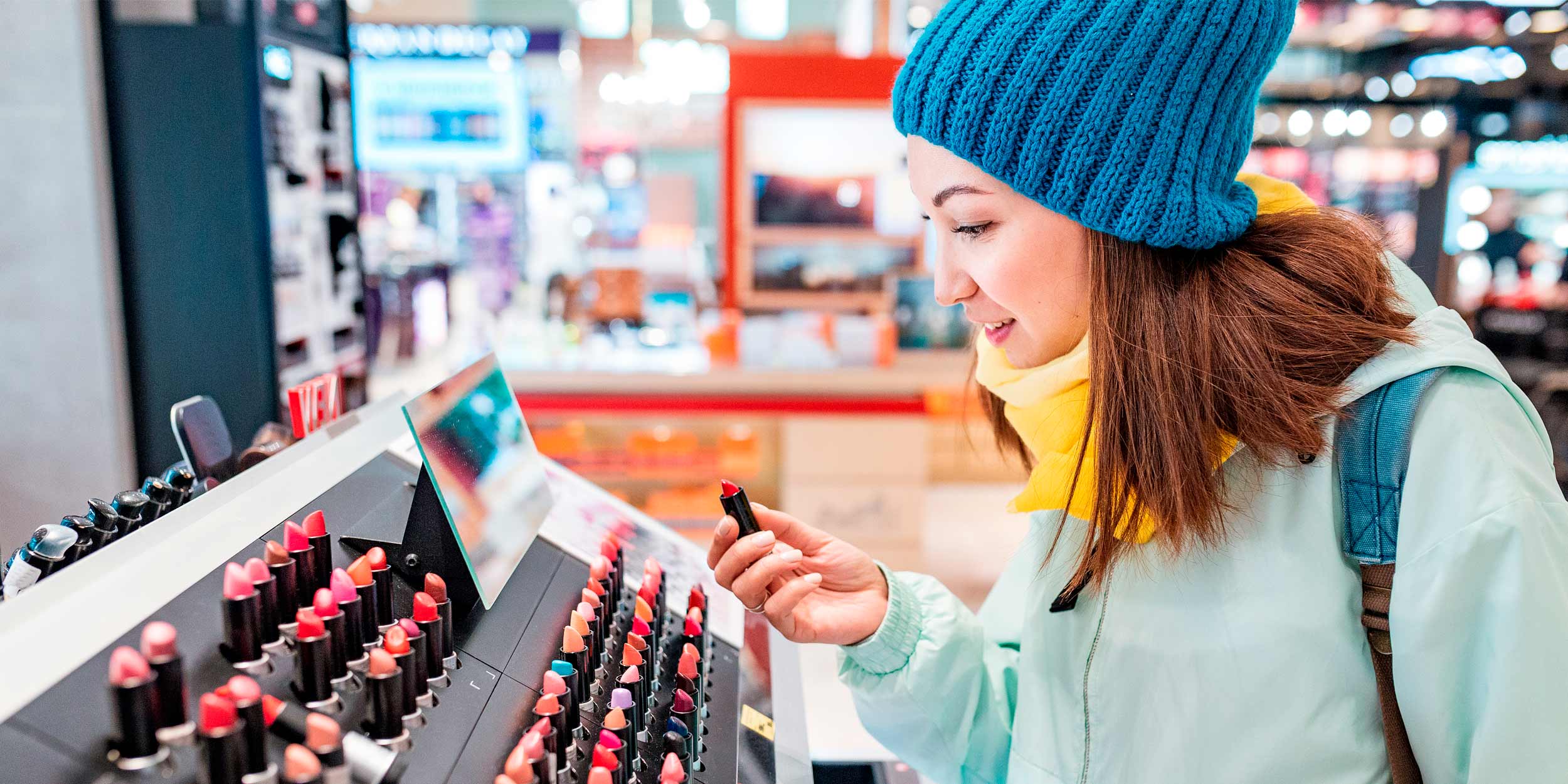 Woman shopping for lipstick and other cosmetics in a store