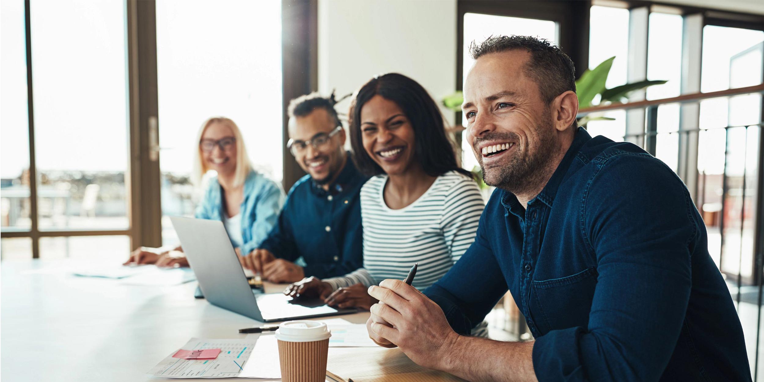 team laughing during meeting